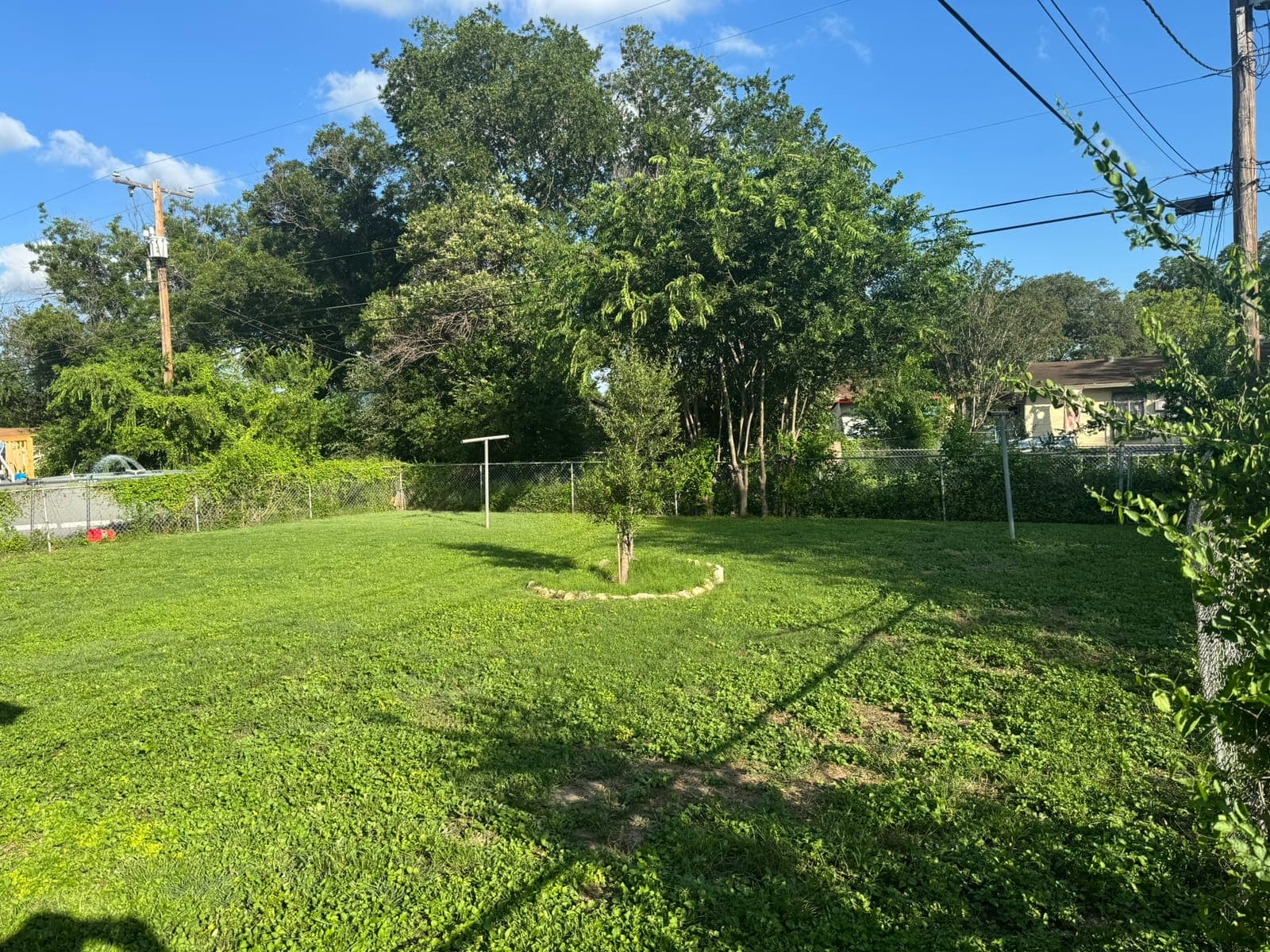 Neatly mowed lawn next to a covered patio